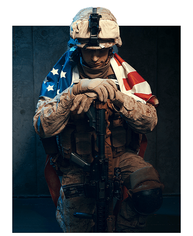 US marine in combat gear holding rifle with American flag, portrait on dark background