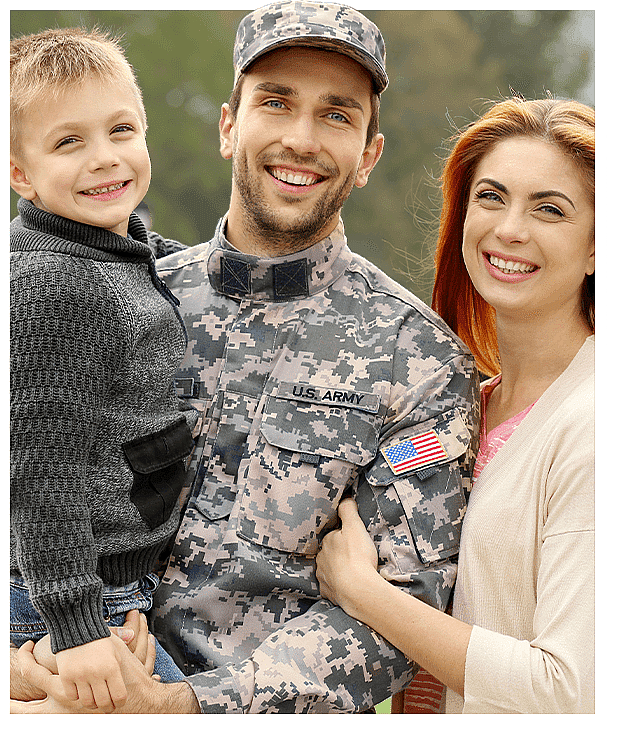 Smiling military family portrait outside - soldier in camouflage uniform with wife and young son